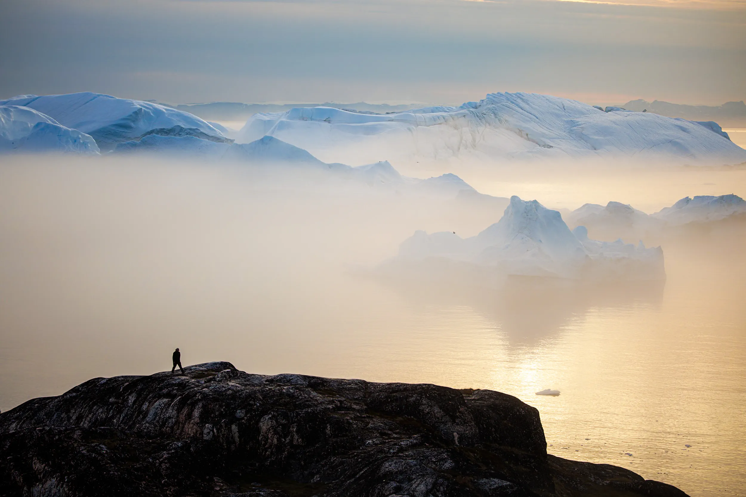 One Figure Watching the Fog Swallow Ice